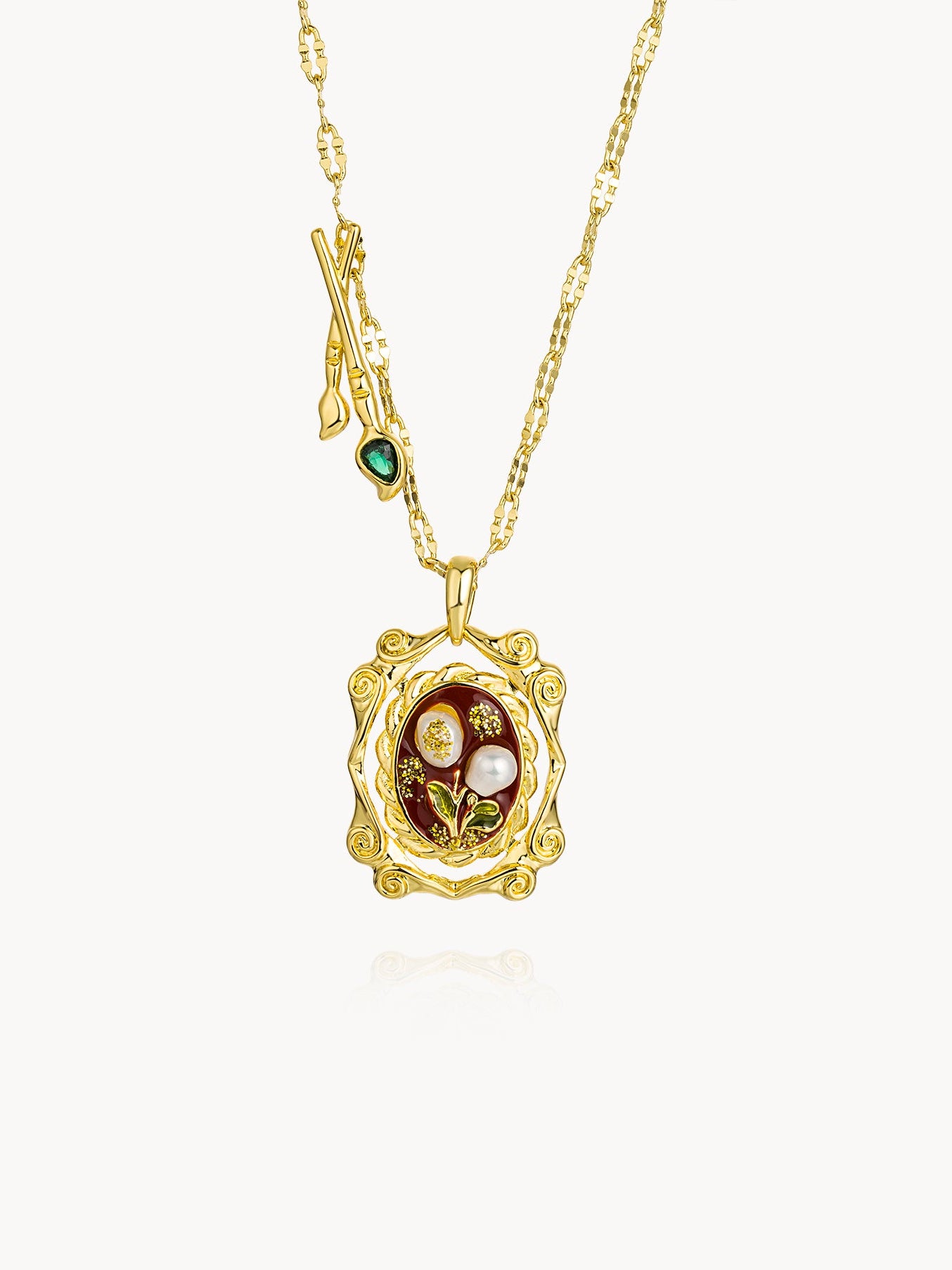 Gold necklace with a decorative pendant featuring pearls and gemstones on a white background